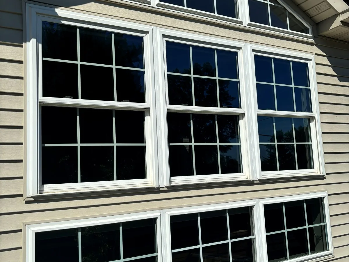Multi-pane windows on a colonial-style home after a full exterior clean