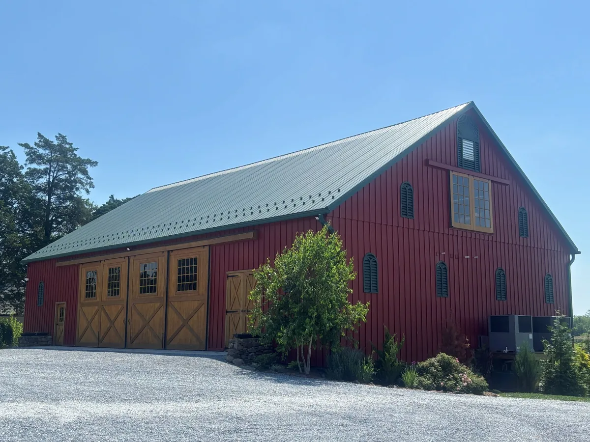 Exterior of a large red barn event venue with freshly cleaned windows